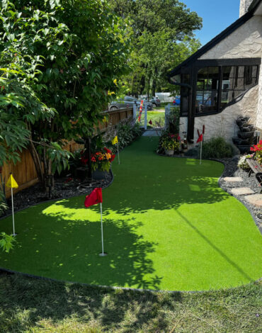 Backyard putting green, paver patio and outdoor fire pit in Silver Heights, Winnipeg